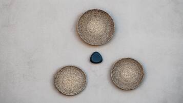 Three woven baskets on a textured wall.