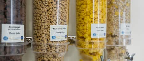 A row of cereal dispensers with labels in a foreign language.