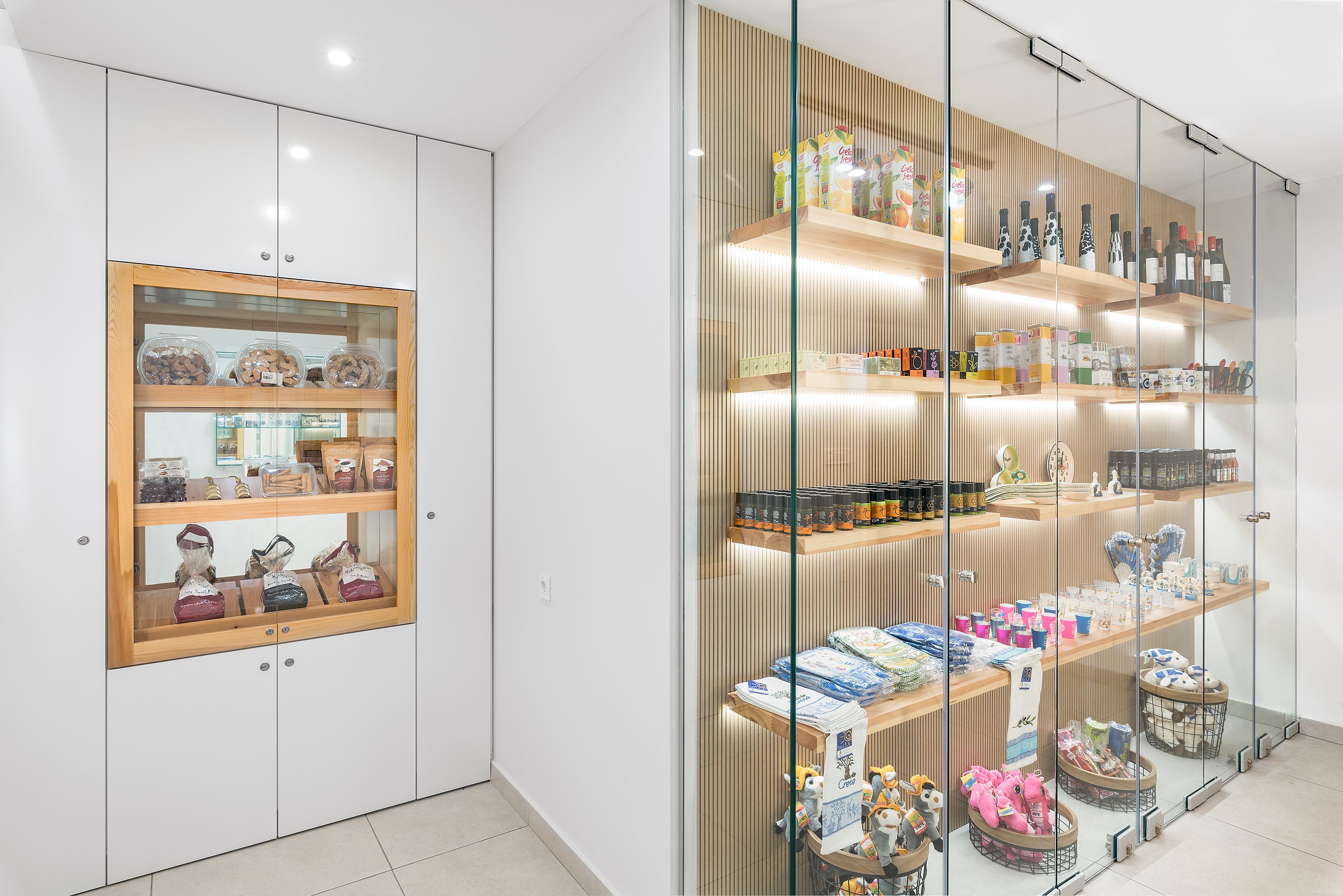 A modern retail space with glass display cases and wooden shelves.