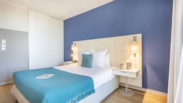 A modern bedroom with a bed, bedside tables, and a nightstand.