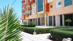A multi-story hotel with a modern architectural design, featuring large windows and balconies. - The Dunes Golf & Spa Resort (Port El Kantaoui)