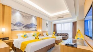 A hotel room with a large bed, a desk, a television, and a painting on the wall. - Tianyue Hotel (Chengdu)
