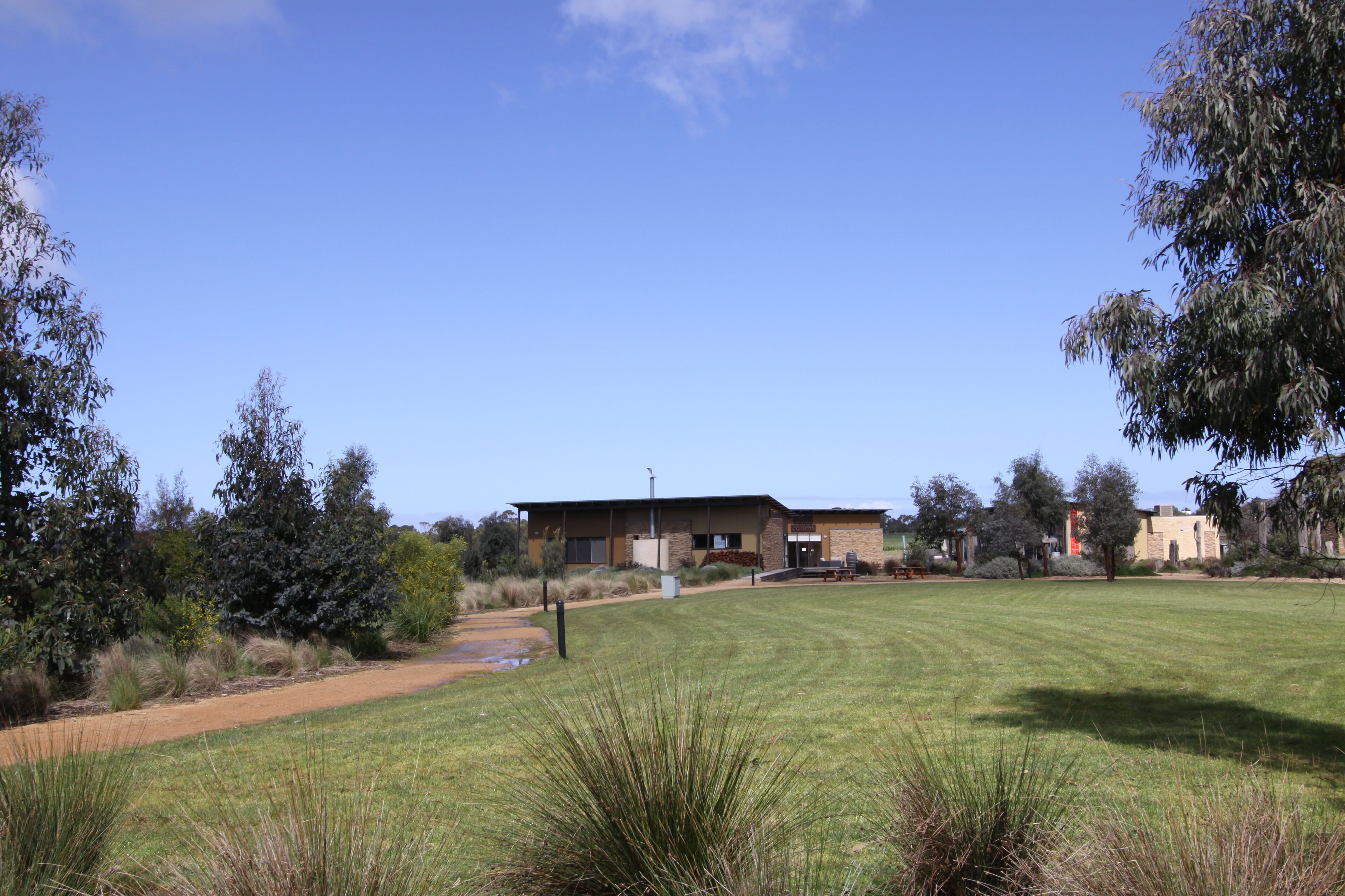 A building with a flat roof and a paved entrance.