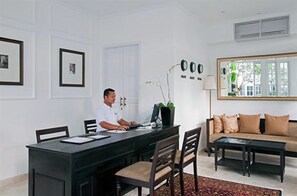 A modern office with a desk, chairs, and a sofa. - The Colony Hotel (Seminyak)