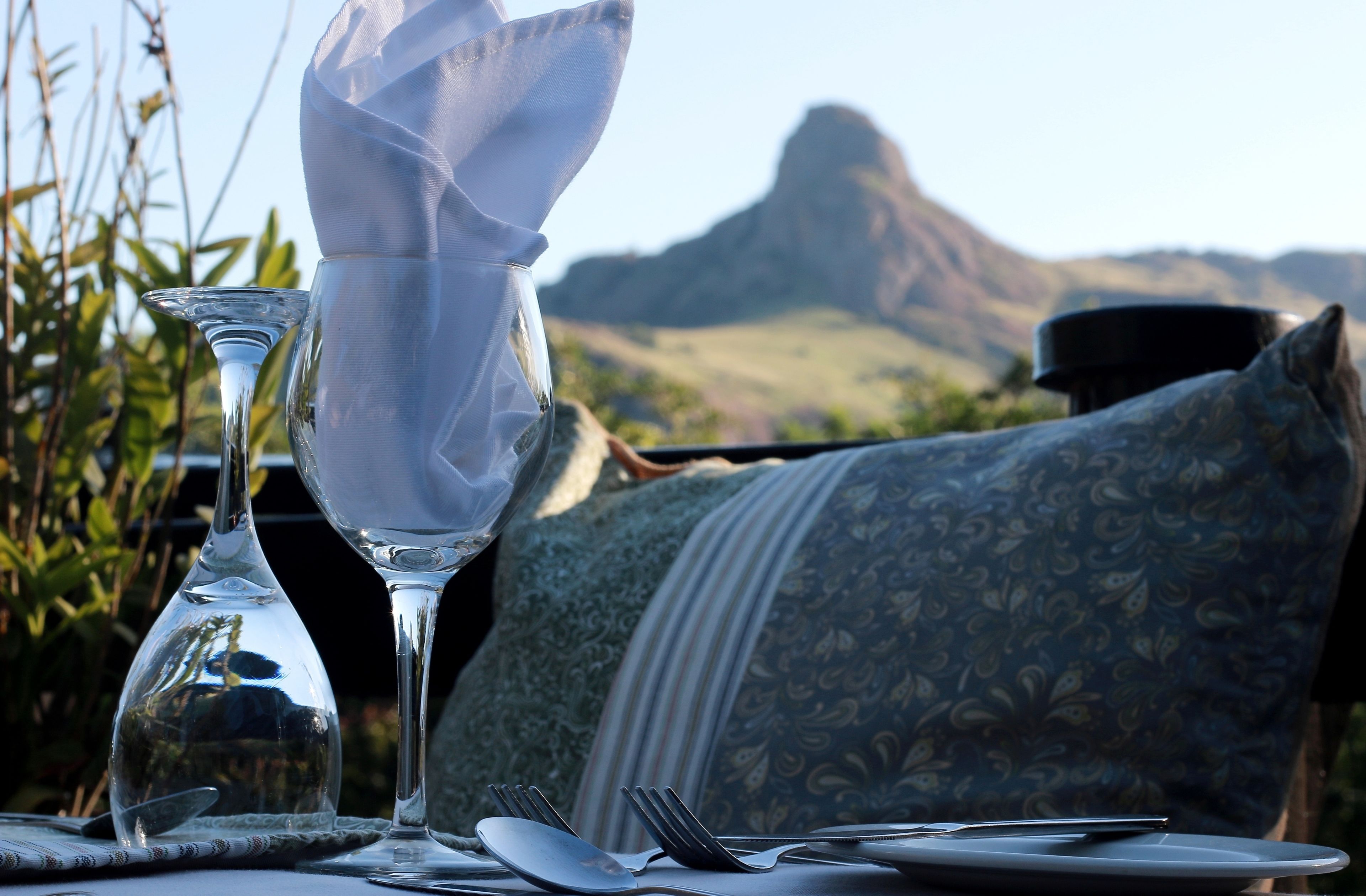 A table set for dining with a clear view of a mountainous landscape in the background.