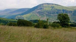 A mountainous landscape with a prominent hill in the center. - Ghyll Farm Bed & Breakfast (Frizington)