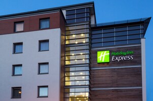 A Holiday Inn Express building with a modern facade, large windows, and a prominent sign.