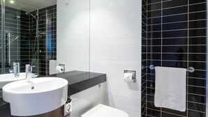 A modern bathroom with a large sink, mirror, and a towel rack. - Holiday Inn Express Harlow by IHG (Harlow)