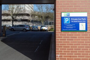 A private car park for hotel guests with a sign indicating it is full use of U-park car park next door. - Holiday Inn Express Harlow by IHG (Harlow)