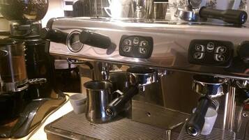 An espresso machine with a digital display and multiple portafilters.