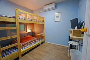 A bunk bed room with a desk, chair, and a small table. - 710 Guest house Yellow (Busan)