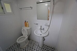 A bathroom with a toilet, sink, and mirror. - 710 Guest house Yellow (Busan)