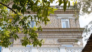 A building with a stone facade, white columns, and a colorful tiled entrance. - Artis Domus Relais & Spa (Sorrento)