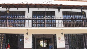Ein Hotel mit Balkon, großen Fenstern und einem Schild mit der Aufschrift 'Hotel Casablanca'.