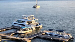 A marina with several boats docked at wooden piers. - Bocas del Mar Hotel (Boca Chica)