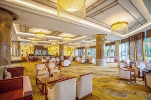 A spacious lobby with multiple seating areas, large columns, and a patterned carpet. - Empark Grand Hotel Tengchong (Baoshan)
