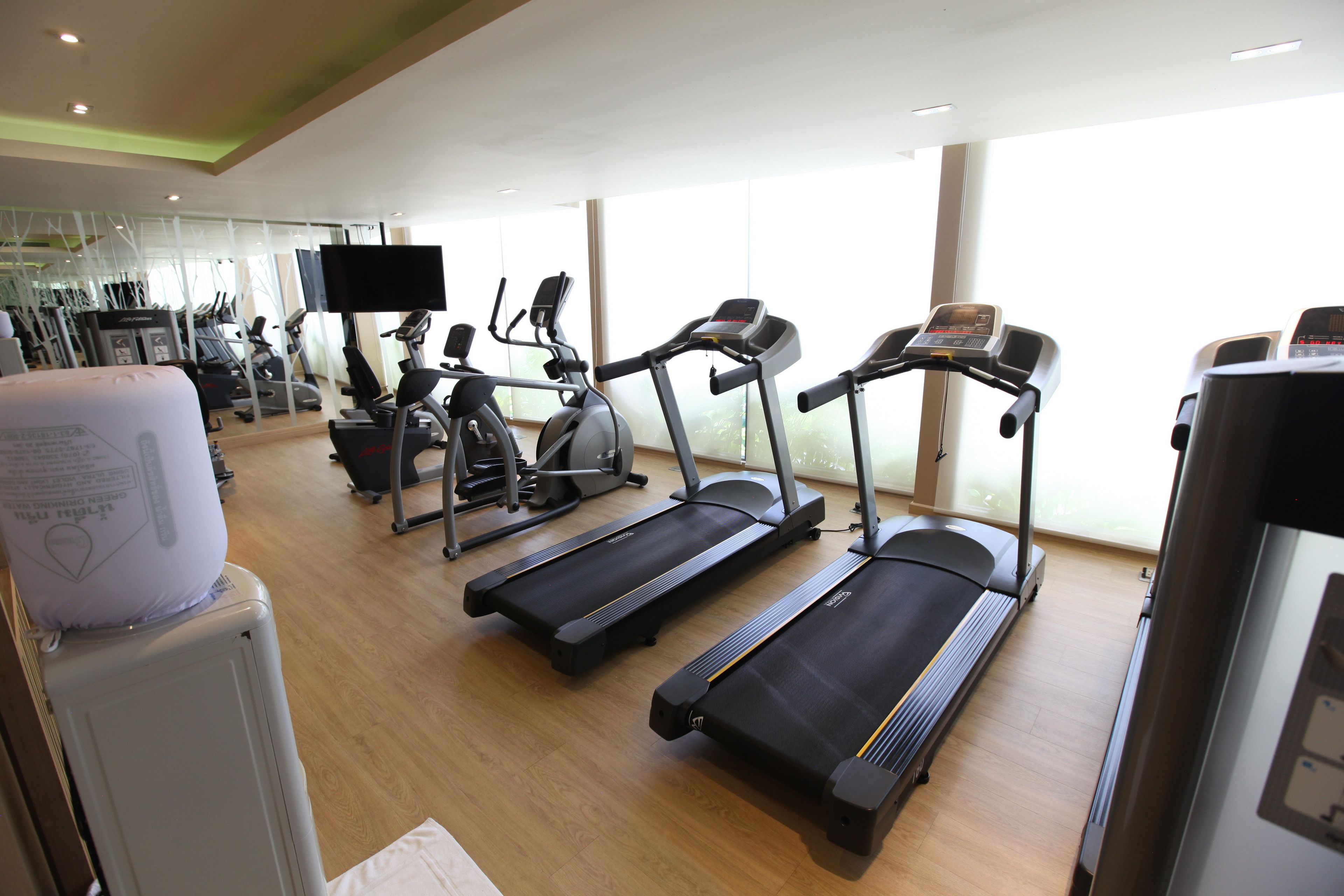A gym with treadmills, stationary bikes, and weight machines.