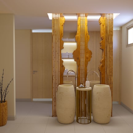 A modern bathroom with a wooden partition, a sink, and two large stools.