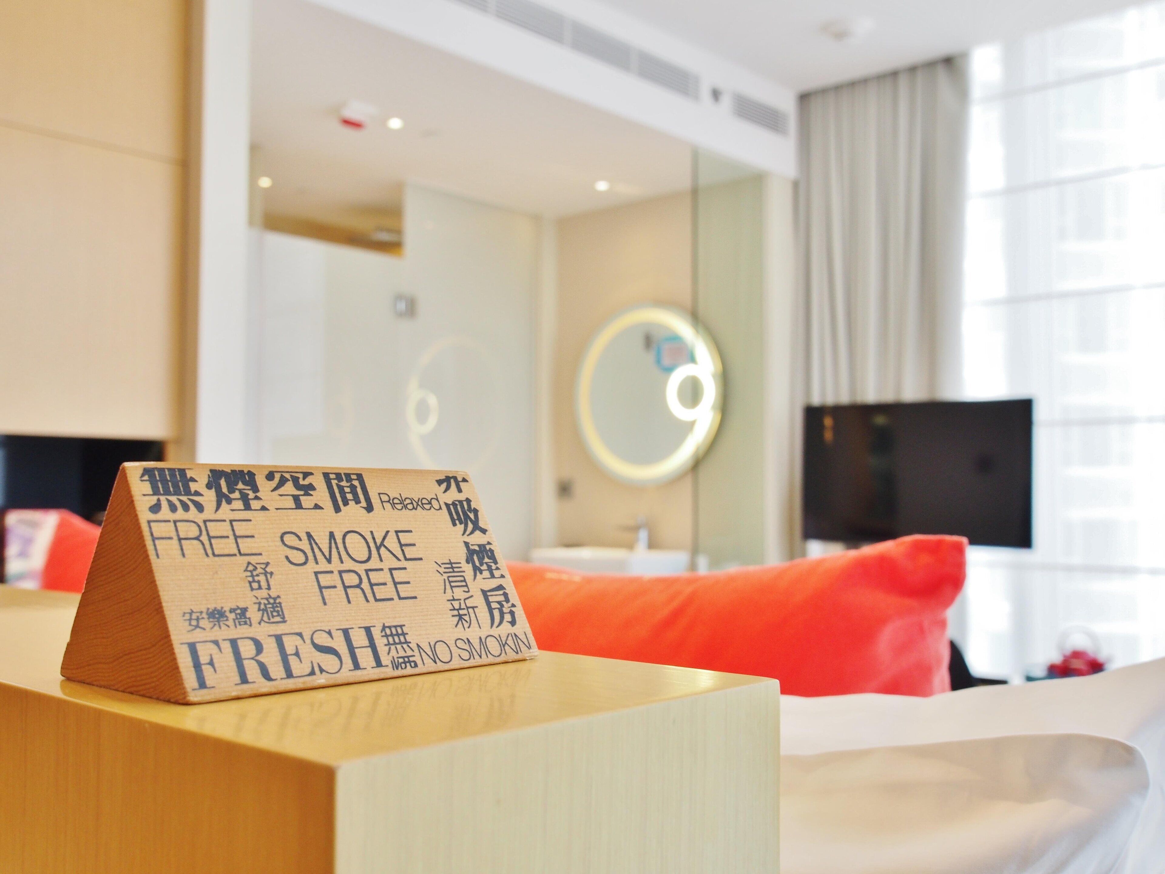 A hotel room with a sign indicating it is a smoke-free and fresh environment.