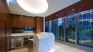 A modern kitchen with a marble island, stainless steel appliances, and large windows offering city views. - Hotel Indigo Hong Kong Island by IHG (Hong Kong)