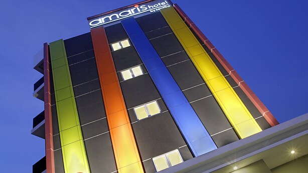 A hotel building with a colorful facade and a prominent 'Maris Hotel' sign. - Amaris Hotel Juanda (Jakarta)