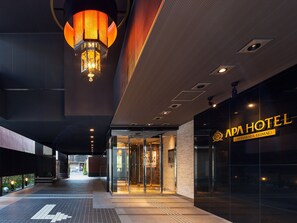 The exterior of APA HOTEL with a modern entrance, a glass door, and a sign displaying the hotel's name. - APA Hotel Akihabara Ekimae (Tokyo)