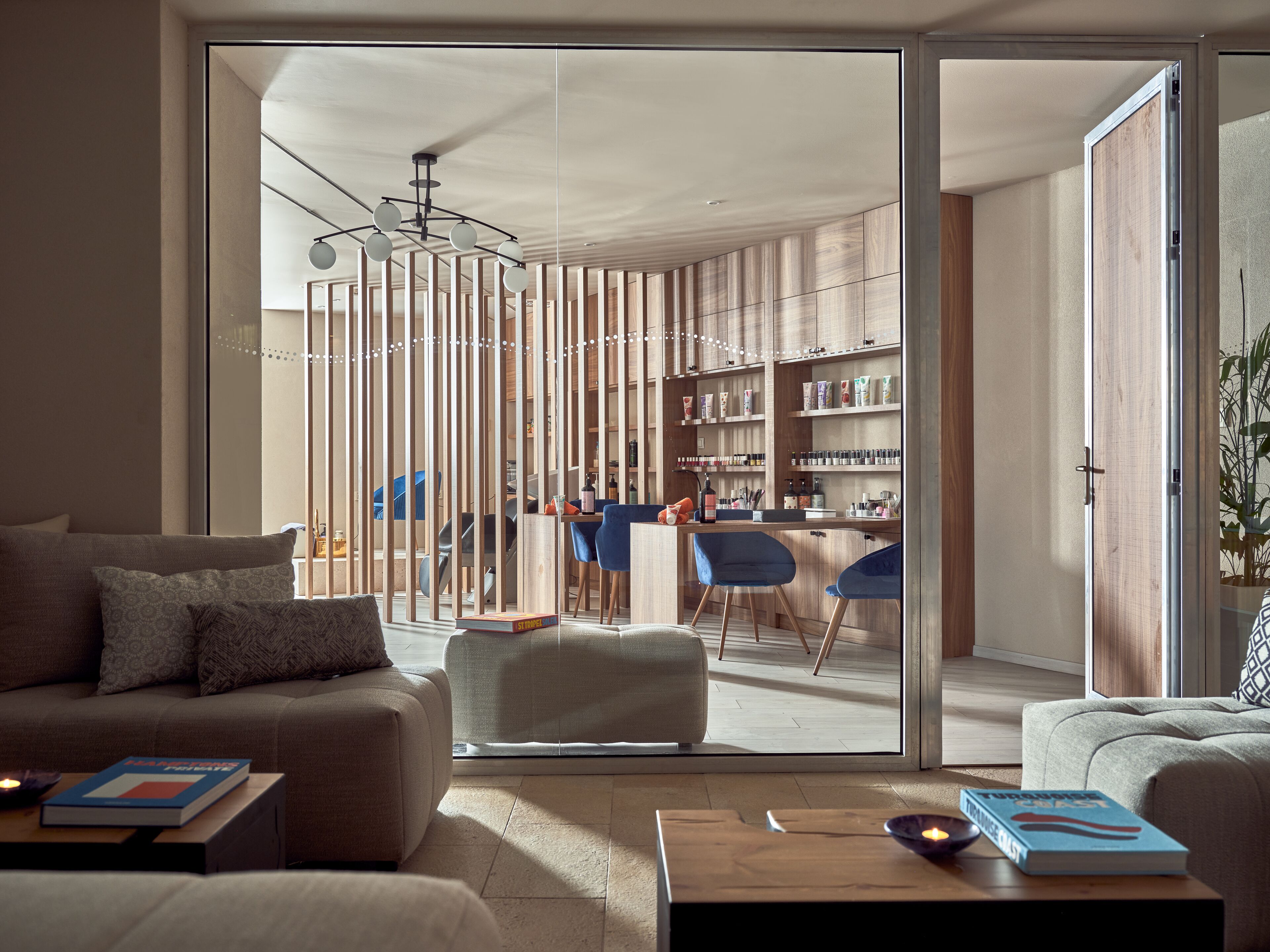 A modern living room with a sofa, a coffee table, and a bookshelf.