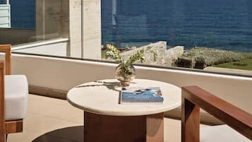 Un espacio al aire libre moderno con una mesa redonda, un libro y un jarrón con plantas.