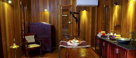 A wooden interior with a dining table, chairs, a bar area, and a traditional tea set.