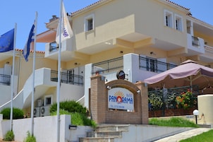 A hotel sign with the name "PANORAMA" and contact information.