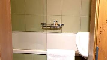 A bathroom with a white toilet, a white sink, and a bathtub.