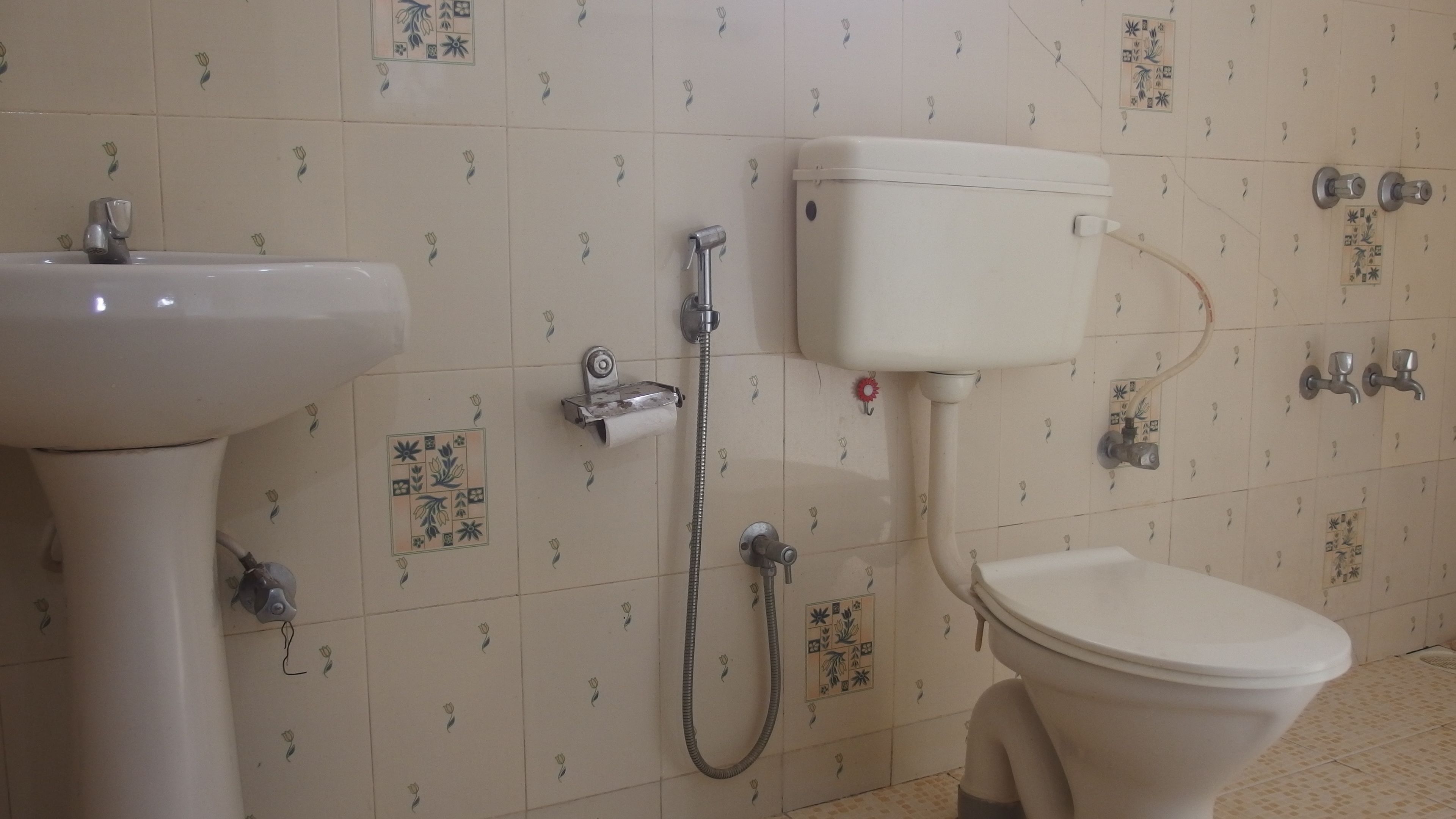 A bathroom with a toilet, bidet, and sink.