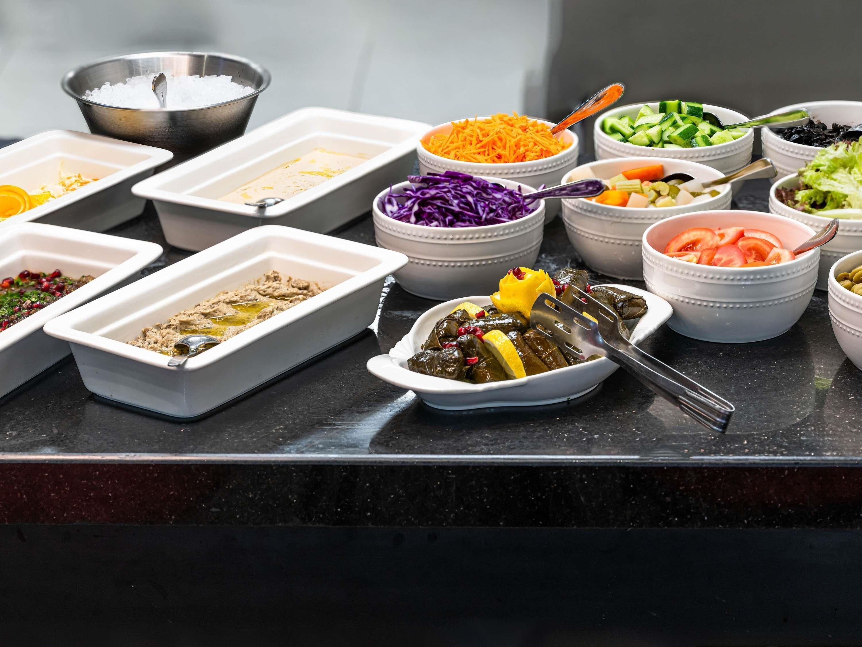 A variety of food items in bowls and containers on a counter.