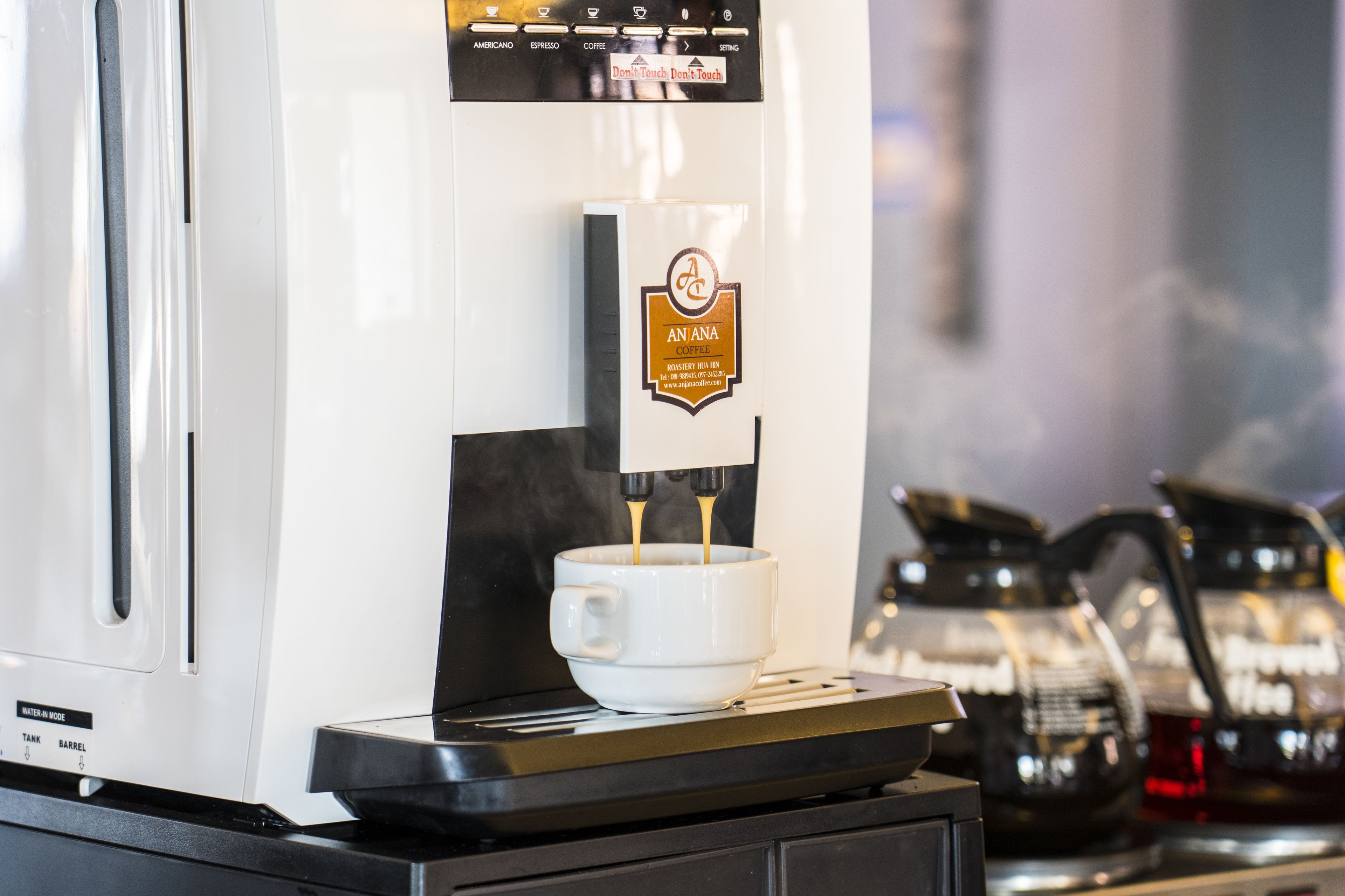 A coffee machine dispensing coffee into a cup.