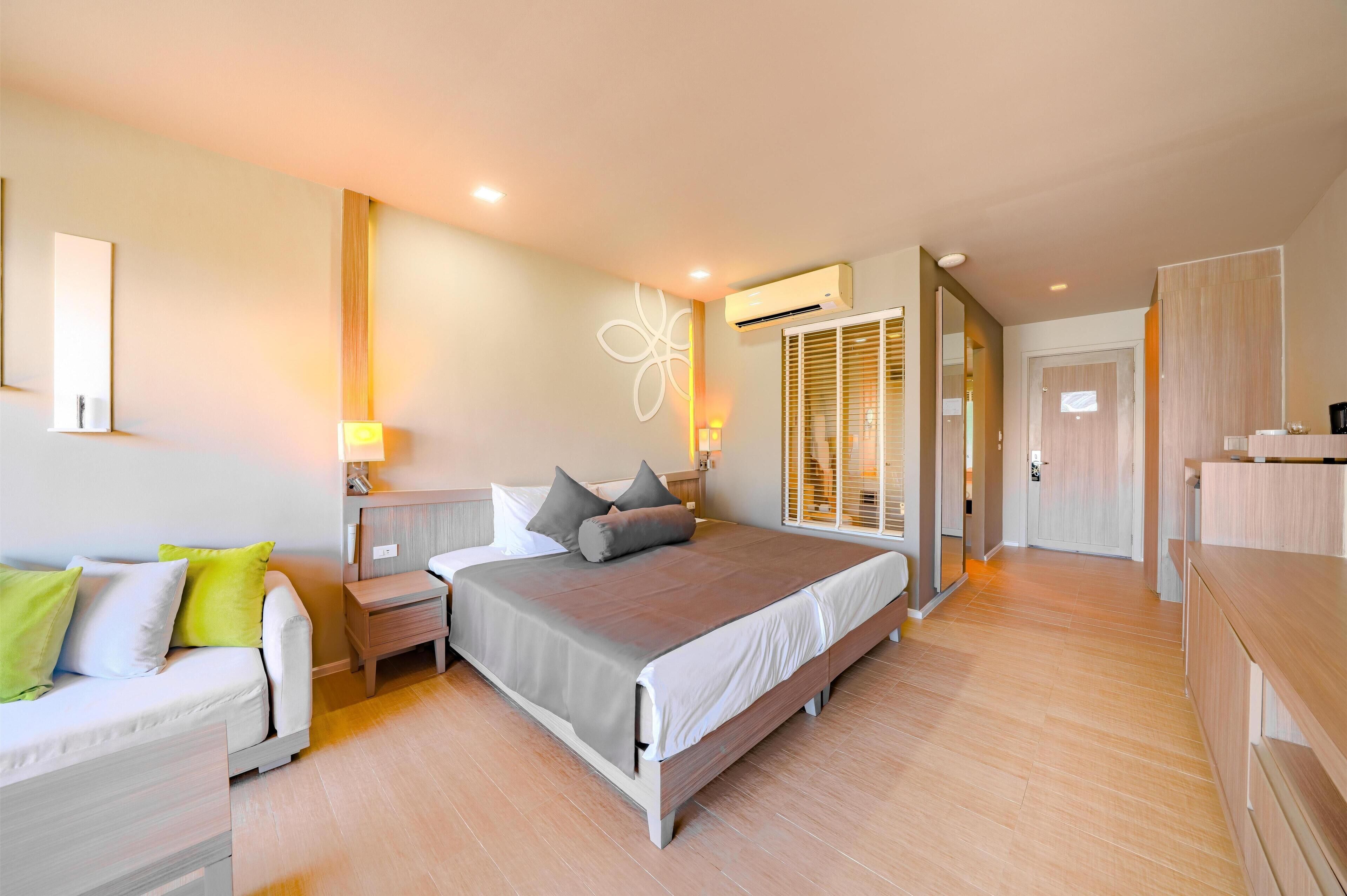 A modern bedroom with a bed, bedside tables, a nightstand, a dresser, and a mirror.