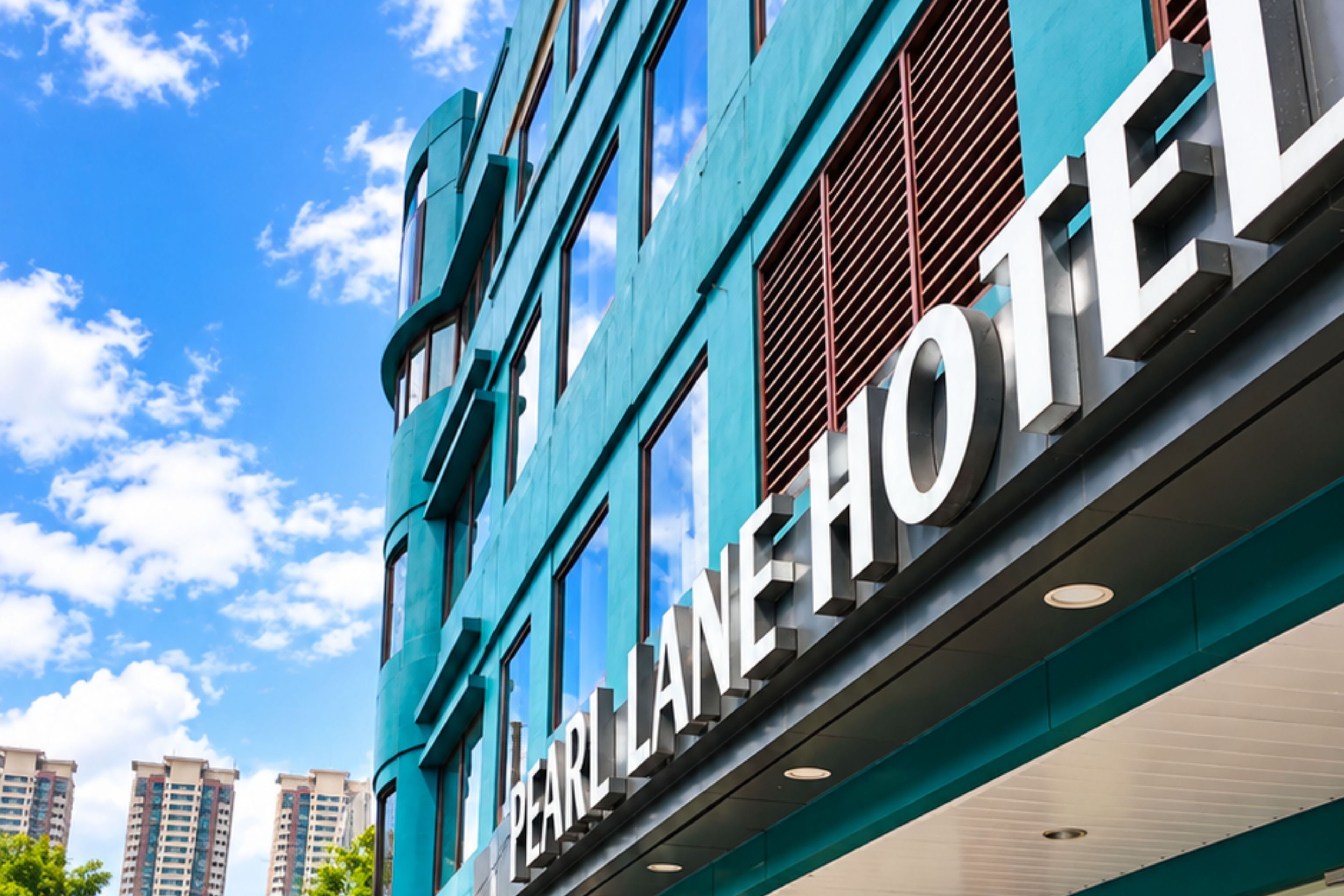 A modern building with the sign 'Pearl Line Hotel' indicating a hotel establishment.