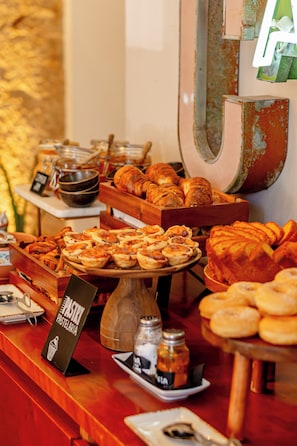 A buffet with various baked goods and pastries.