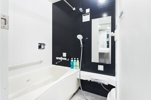 Bañera con ducha, secador de pelo, pantuflas, bidet