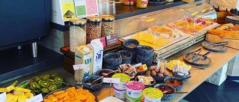 A buffet with various food items and condiments.