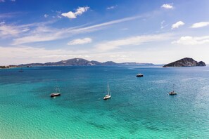 A coastal scene with clear turquoise waters and several sailboats. - Villa Phoenix Apartments & Studios (Zakynthos)