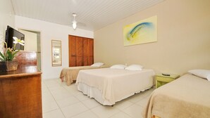 A hotel room with two beds, a desk with a TV, a ceiling fan, and a painting on the wall. - Pousada Areias Brancas (Búzios)