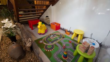 Children can play and explore in this fun play area featuring a miniature train set and toys.