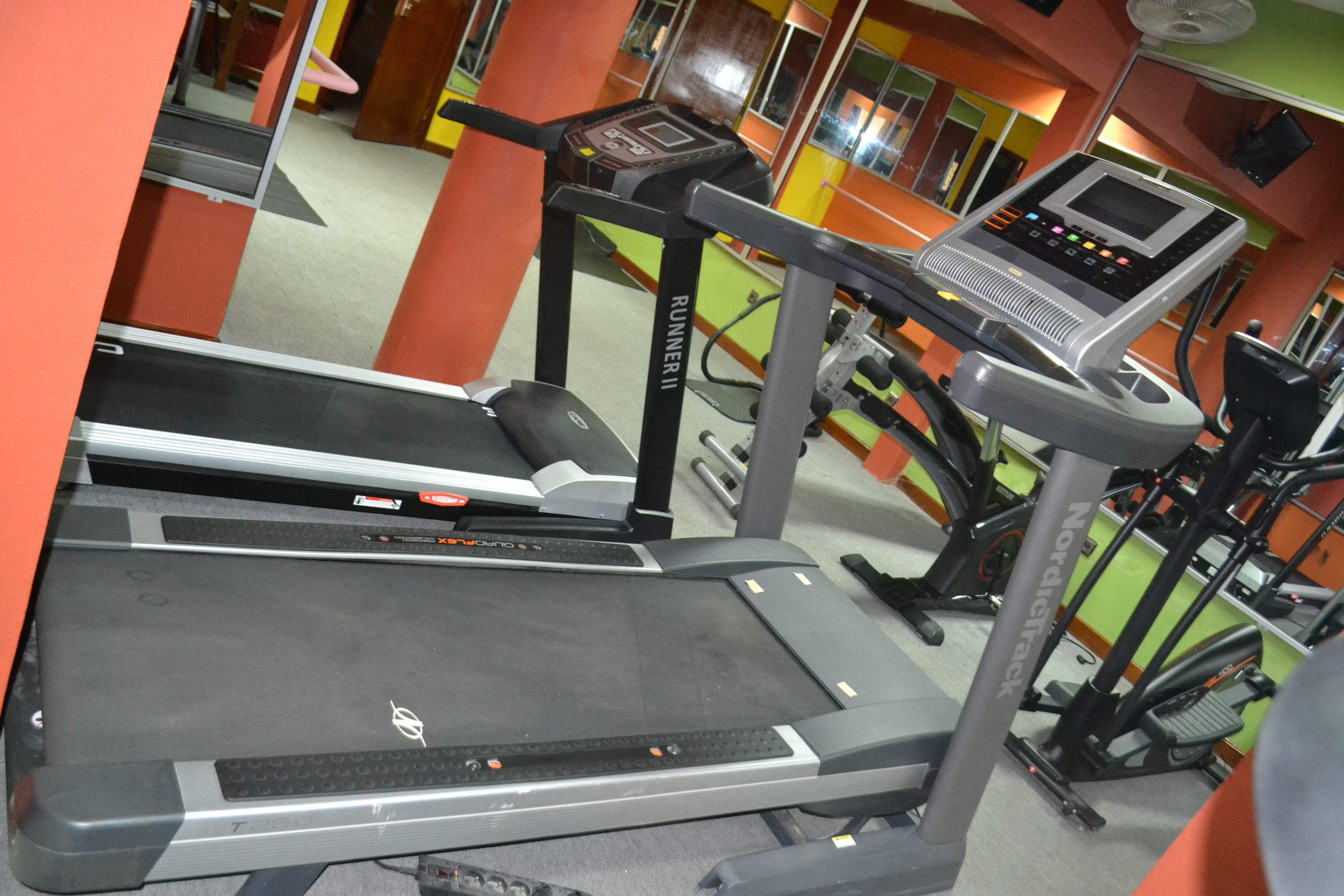 A gym with treadmills and exercise equipment.