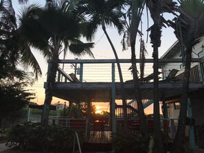 A two-story building with a balcony overlooking a sunset. - La Jamaca (Lajas)
