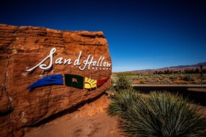 A large rock with the text "Sand Hollow Resort" and a logo.