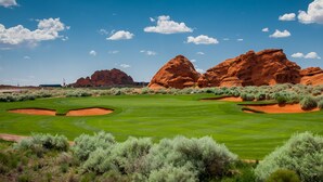A golf course with red rock formations in the background. - Vacation Rentals at Sand Hollow Resort (Hurricane)