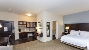 A hotel room with a bed, a desk, a chair, a kitchenette, and a bathroom. - Staybridge Suites Bowling Green by IHG (Bowling Green)