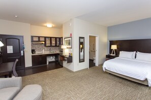 A hotel room with a bed, a desk, a chair, a kitchenette, and a bathroom. - Staybridge Suites Bowling Green by IHG (Bowling Green)