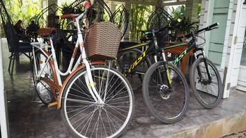 A covered outdoor area with bicycles parked.