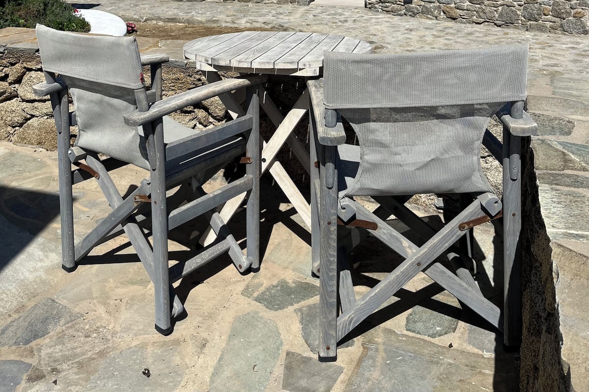 A terrace with outdoor seating and a view of the sea.